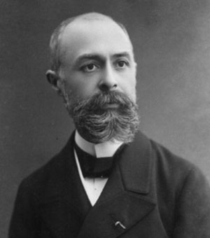 Henri Becquerel, bearded French physicist in a dark formal coat.